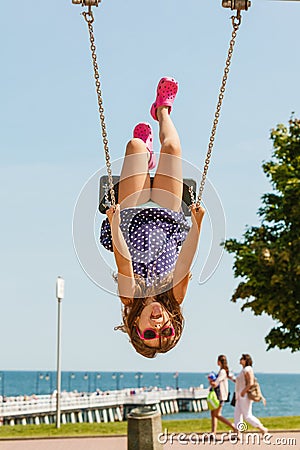 Playful crazy girl on swing. Stock Photo