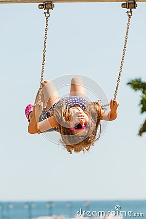 Playful crazy girl on swing. Stock Photo