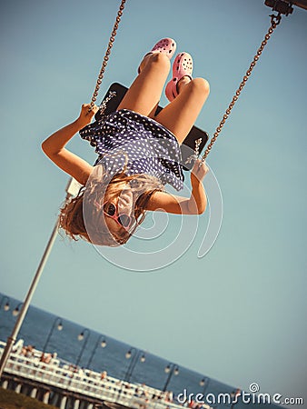 Playful crazy girl on swing. Stock Photo