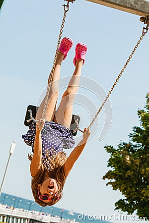 Playful crazy girl on swing. Stock Photo