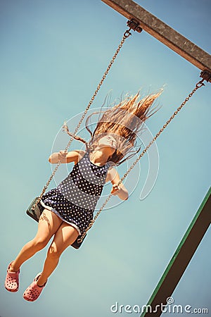 Playful crazy girl on swing. Stock Photo