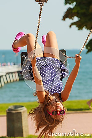 Playful crazy girl on swing. Stock Photo