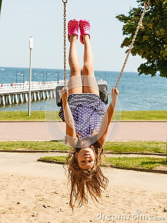 Playful crazy girl on swing. Stock Photo