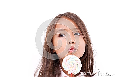 Playful cute little girl with sweet colorful marshmallow Stock Photo
