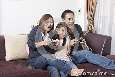 Playful family playing video games Stock Photo