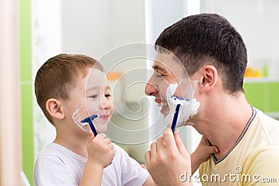 Playful father and son shaving together at home bathroom Stock Photo