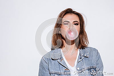 Playful lady blowing bubble with chewing gum. Stock Photo