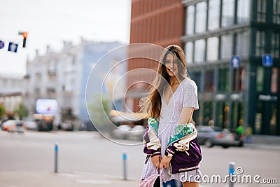 Playful portrait of pretty young woman, having fun at the street. Stock Photo