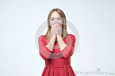 Playful shy woman hiding face laughing timid. Stock Photo