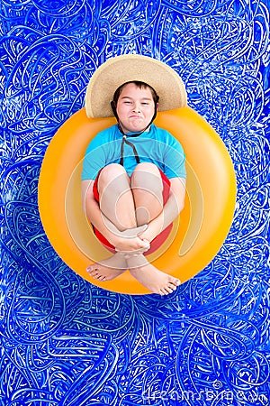 Playful young boy in a summer swimming pool Stock Photo