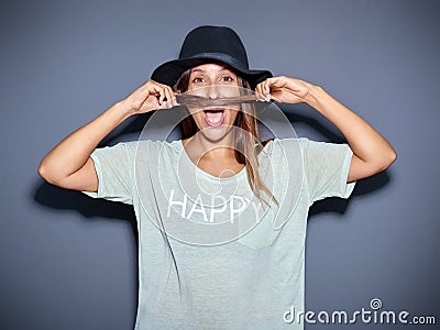Playful young woman making a pretence moustache Stock Photo