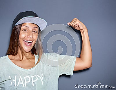 Playful young woman pumping her muscles Stock Photo