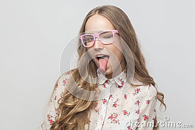 Playfully young woman in pink eyeglasses, looking at camera, ton Stock Photo