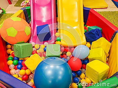 Playground, children`s slides, a play area of colorful plastic balls. Cheerful children`s leisure with balls in the play pool, o Stock Photo