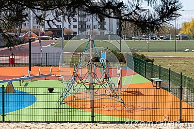 A playground for children to play. Colorful play sets and a safe surface. Coniferous tree branch with cones. Pine. Stock Photo