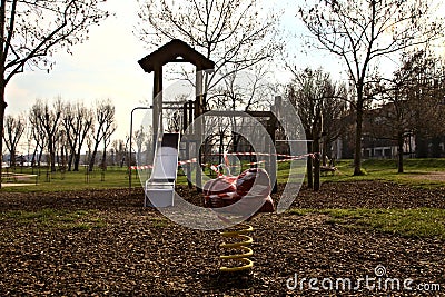 Playground with equipments wrapped in red and white tape to prevent usage during the Covid pandemic Editorial Stock Photo