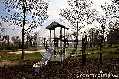 Playground with equipments wrapped in red and white tape to prevent usage during the Covid pandemic Editorial Stock Photo