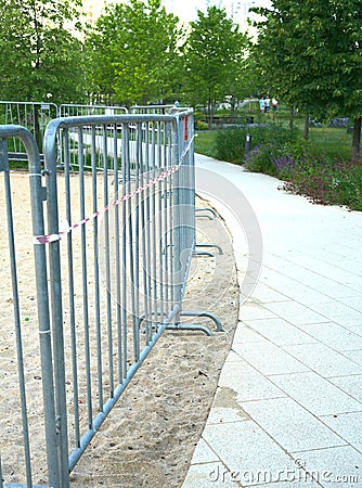 The playground is fenced with metal barriers due to restrictive measures in connection with the Covid pandemic Stock Photo