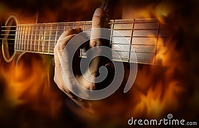 Playing acoustic guitar with fire flame screen. Stock Photo