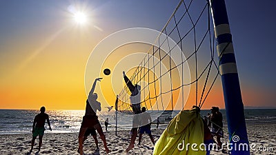 Playing beach volleyball at dusk Editorial Stock Photo