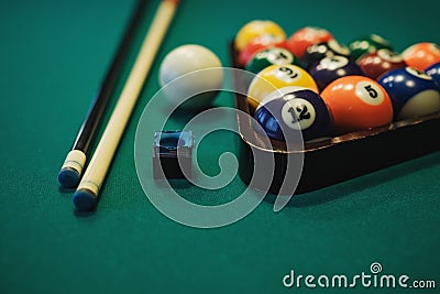 Playing billiard. Billiards balls and cue on green billiards table. Billiard sport concept. Stock Photo