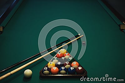 Playing billiard. Billiards balls and cue on green billiards table. Billiard sport concept. Stock Photo