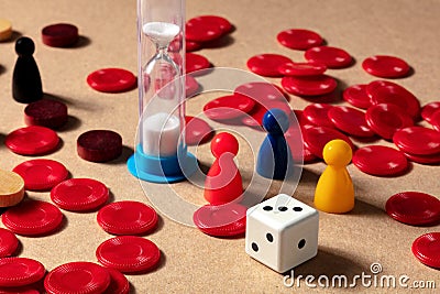 Playing board games at home, various pieces with a timer and a die cube Stock Photo