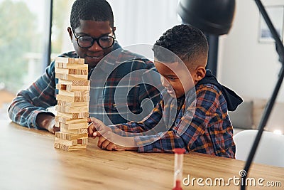 Playing bricks game. African american father with his young son at home Stock Photo