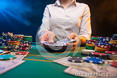 Playing cards in a casino. A lot of chips, money. A player in a casino makes bets. Poker Stock Photo