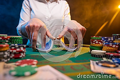 Playing cards in a casino. A lot of chips, money. A player in a casino makes bets. Poker Stock Photo