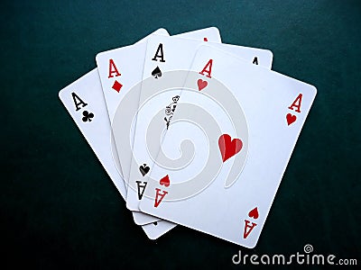 Playing cards on green background. Set of four aces. Stock Photo