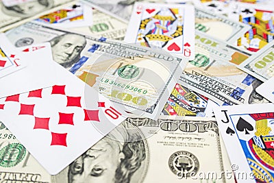 Playing cards and hundred-dollar bills as a background. Casino, Play Game, Gambling Concept. Game addiction. Losing wealth in a Editorial Stock Photo