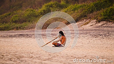 Playing didgeridoo at Mermejita beach Editorial Stock Photo