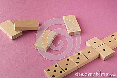 Playing dominoes on a purple background. Leisure games concept. Domino effect Stock Photo