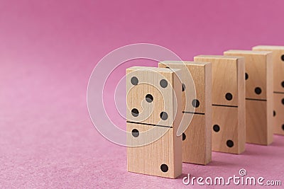 Playing dominoes on a purple background. Leisure games concept. Domino effect Stock Photo