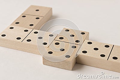 Playing dominoes on a white background. Leisure games concept. Domino effect Stock Photo