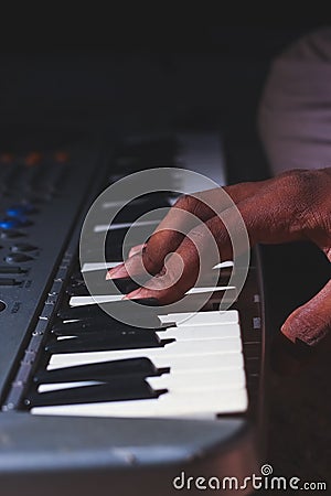 Playing the Electronic Keyboard in Music Recording studio close up on hands. Playing electronic Piano Stock Photo