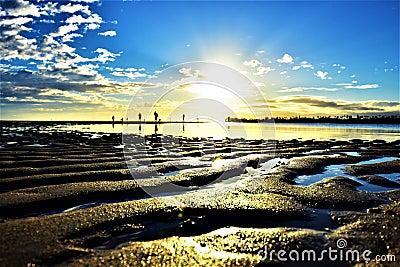 Beautiful sunset and silhouette of a family at Hickam Beach, Hawaii Stock Photo