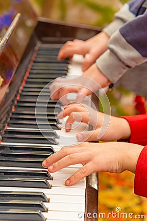 Playing the four hands piano, side view Stock Photo