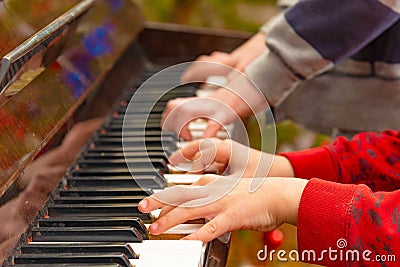 Playing the four hands piano, side view Stock Photo