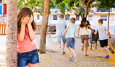 Playing hide and seek. Girl covering eyes her hands Stock Photo