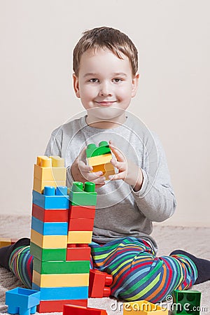 Playing little boy with colored cubes Stock Photo