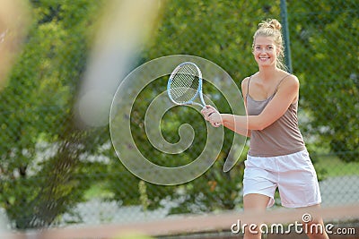 She playing outdoor tennis Stock Photo