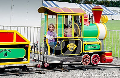 Playing in a small train at an outdoor festival Editorial Stock Photo