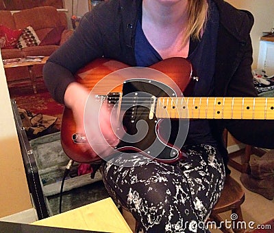 Playing or strumming a guitar. Blurred hand movement. Stock Photo