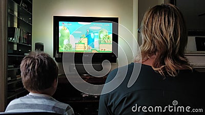 Playing Super Mario Bros on wii with mama Editorial Stock Photo