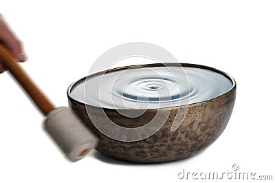 Playing Tibetian singing bowl on white Stock Photo