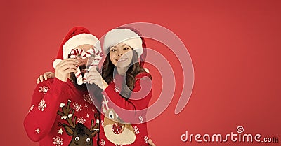 Playing together. Joy and happiness. Christmas Carol. Father and daughter with candy canes christmas decorations. Family Stock Photo