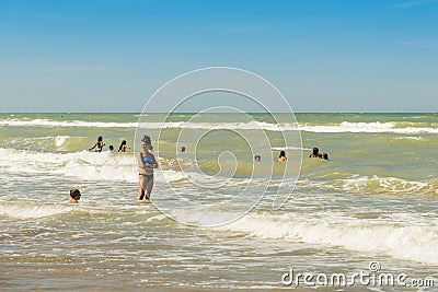 Playing in waves at Silvi Marina beach Editorial Stock Photo