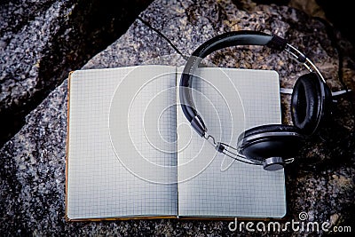 Playlist, notebook Headphones Stock Photo